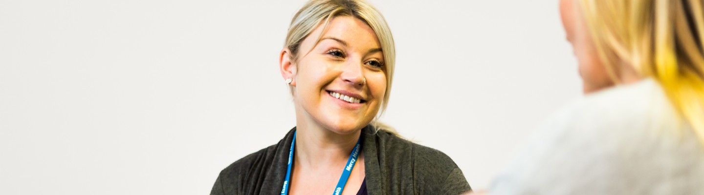 Woman smiling at another woman