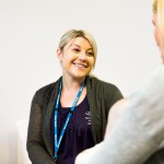 Woman smiling at another woman